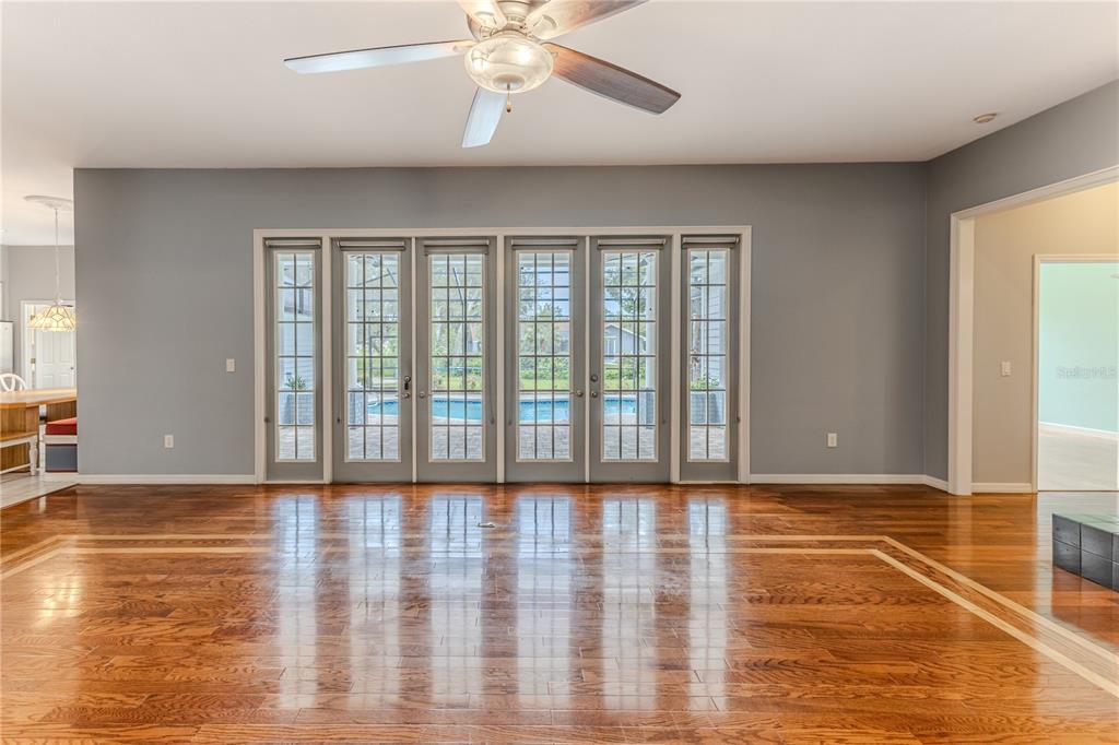 7512 Oak Tree Lane Spring Hill, FL 34607 - Photo 26 of 89 a view of an empty room with wooden floor and a window