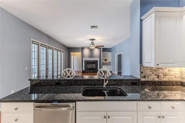 a spacious bathroom with a double vanity sink a mirror and a bathtub