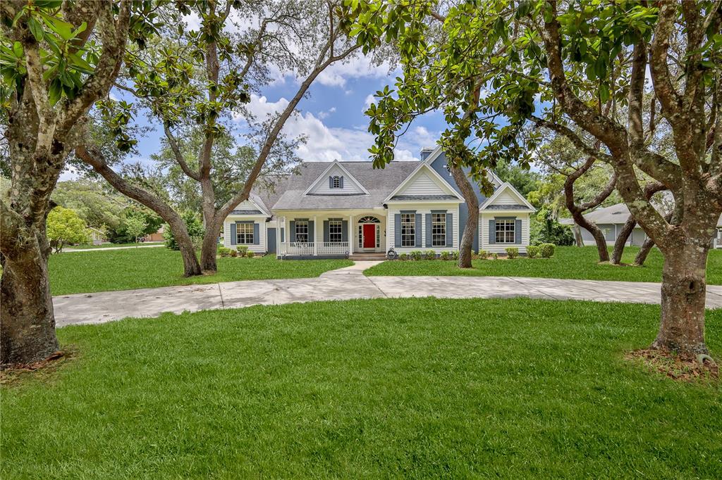 7512 Oak Tree Lane Spring Hill, FL 34607 - Photo 6 of 89 a front view of a house with a yard
