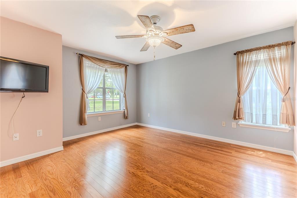 7512 Oak Tree Lane Spring Hill, FL 34607 - Photo 68 of 89 a view of an empty room with a window and wooden floor