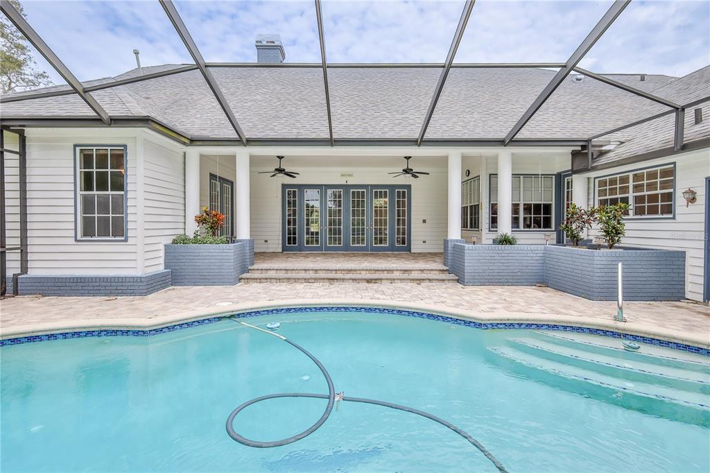 7512 Oak Tree Lane Spring Hill, FL 34607 - Photo 78 of 89 a swimming pool with potted plants in front of it