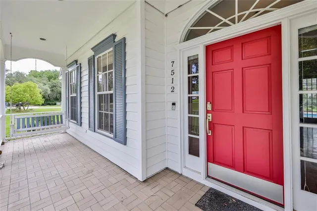 a view of an empty room with window and bathroom