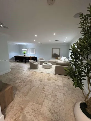 a large white kitchen with stainless steel appliances kitchen island granite countertop a sink and cabinets