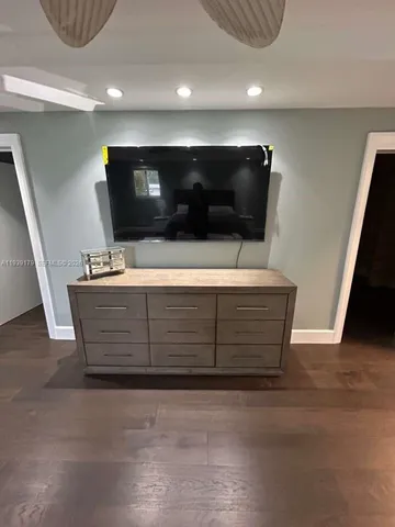a large kitchen with kitchen island granite countertop a large counter top and wooden cabinets