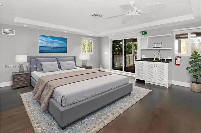 a spacious bedroom with a large bed and a chandelier