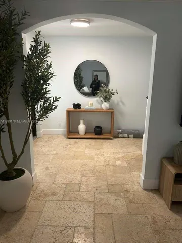 a bathroom with a granite countertop sink a toilet and mirror