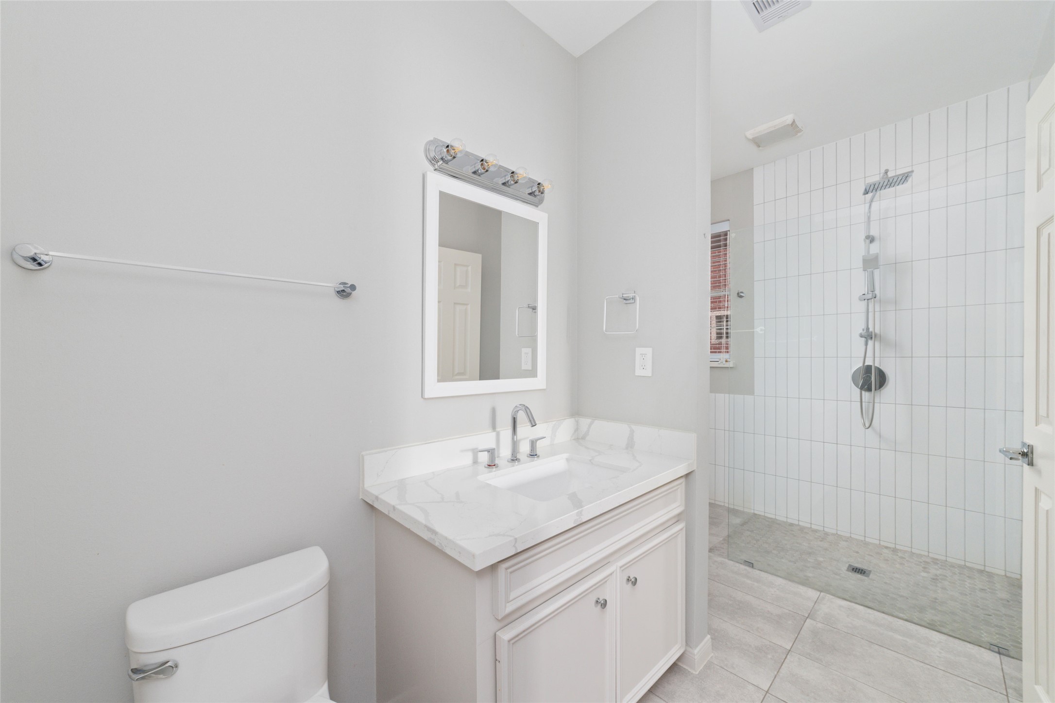 1516 Park Street, Unit B Houston, TX 77019 - Photo 16 of 20 a bathroom with a granite countertop sink a toilet and shower