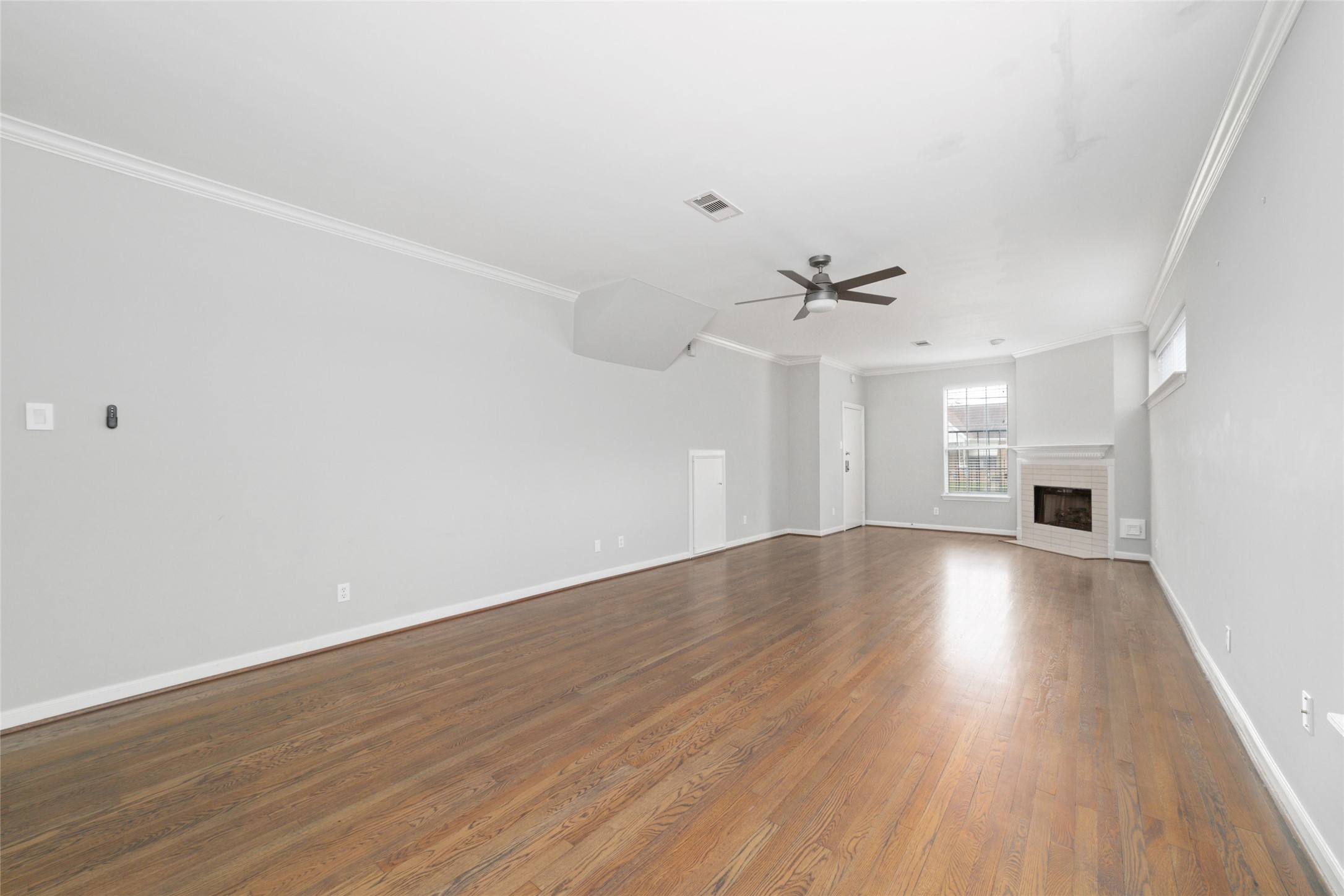 1516 Park Street, Unit B Houston, TX 77019 - Photo 4 of 20 a view of a livingroom with wooden floor and a ceiling fan