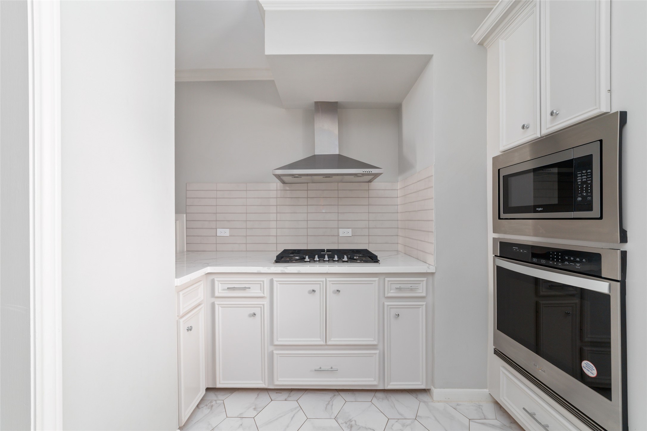 1516 Park Street, Unit B Houston, TX 77019 - Photo 8 of 20 a kitchen with white cabinets and stainless steel appliances