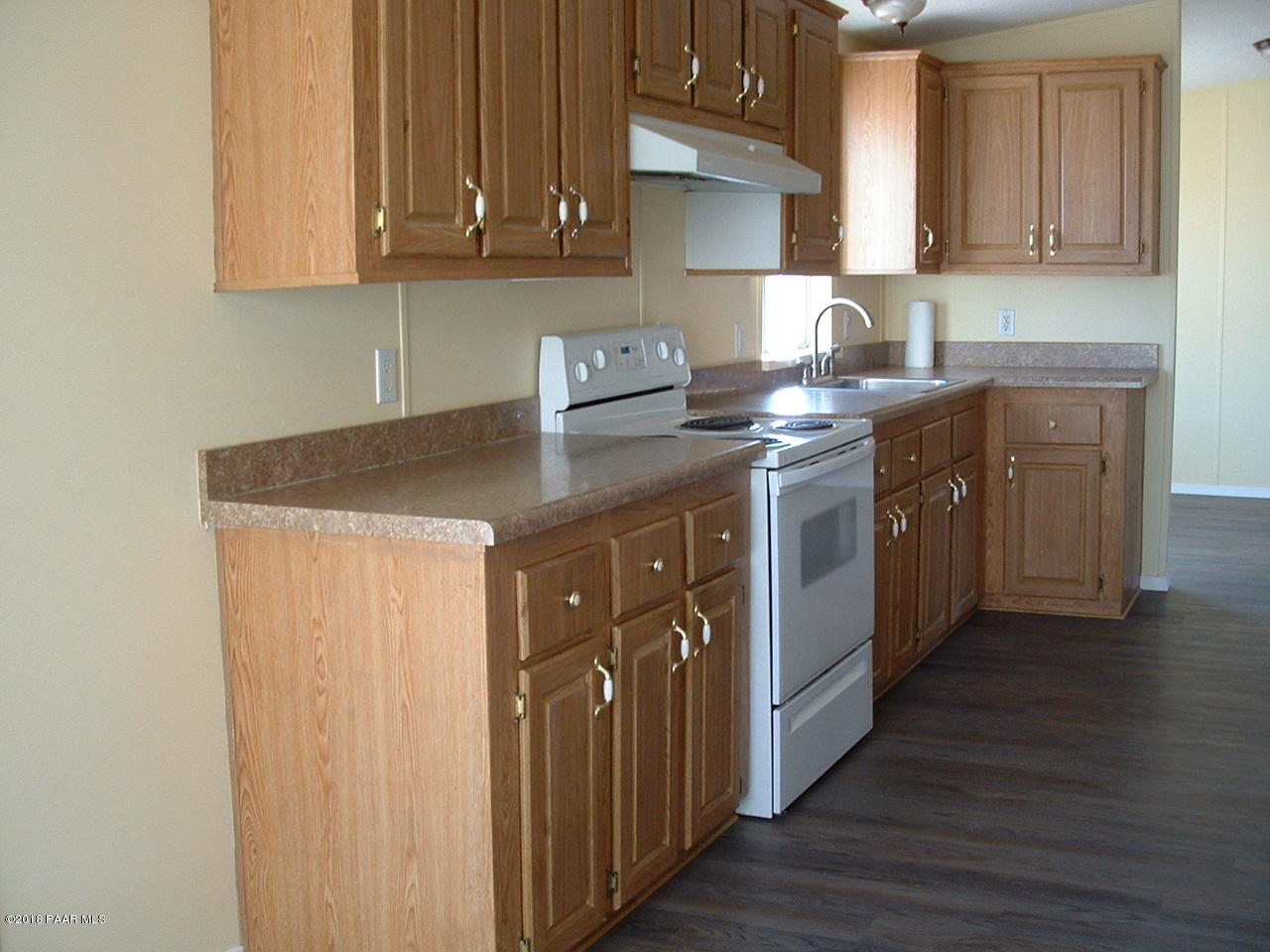 1725 West Big Sky Ranch Road Paulden, AZ 86334 - Photo 14 of 30 a kitchen with stainless steel appliances granite countertop a sink stove and cabinets