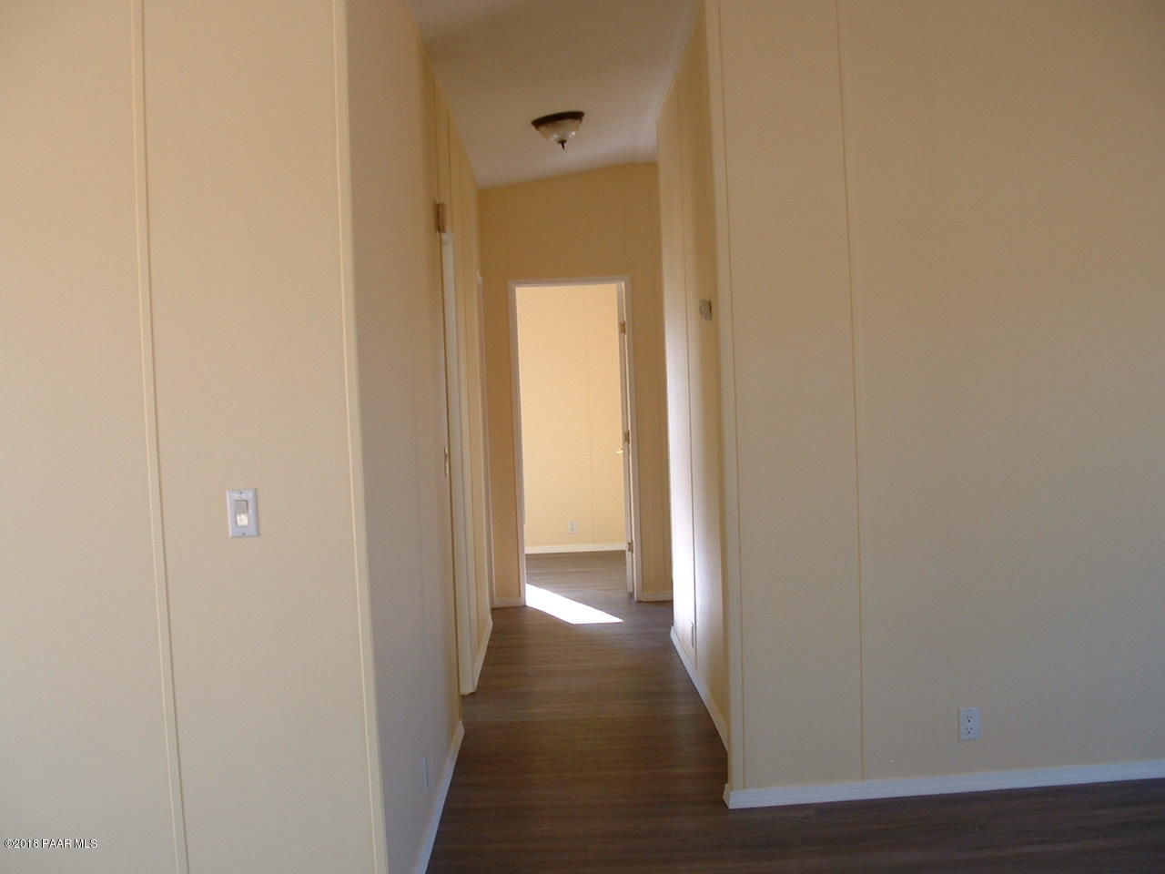 1725 West Big Sky Ranch Road Paulden, AZ 86334 - Photo 22 of 30 a view of a hallway with wooden floor