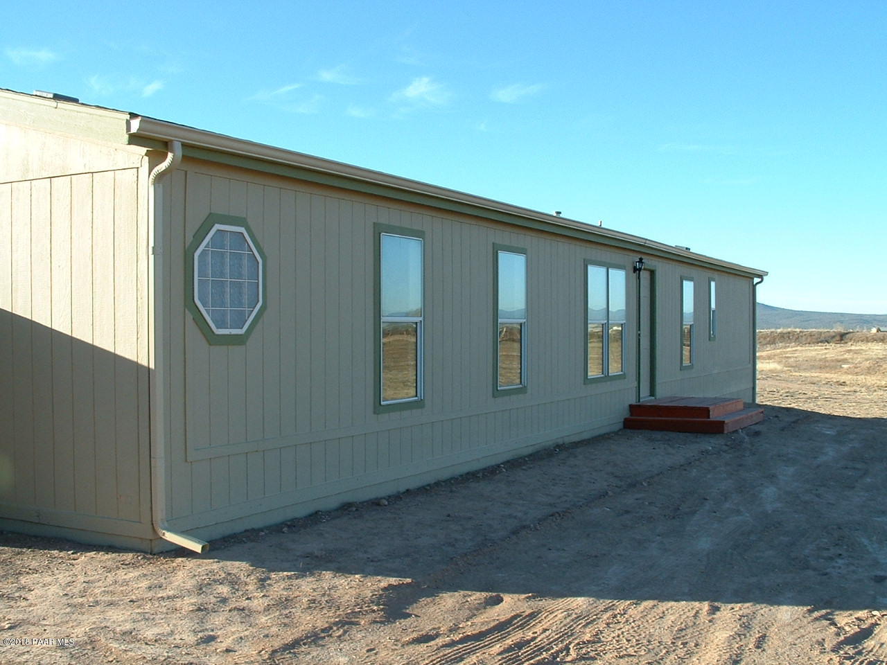 1725 West Big Sky Ranch Road Paulden, AZ 86334 - Photo 5 of 30 a view of a room that has a bed and wooden floor