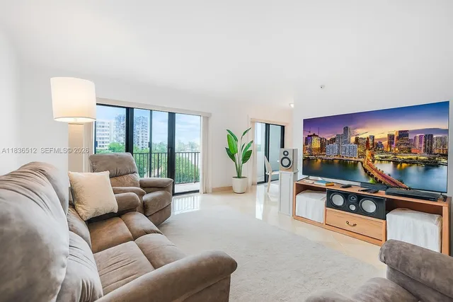a living room with furniture a lamp and a potted plant