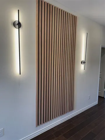 a view of a room with a ceiling fan and wooden floor