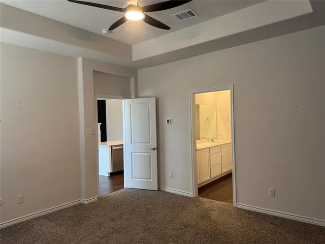 a view of empty room with a ceiling fan and window