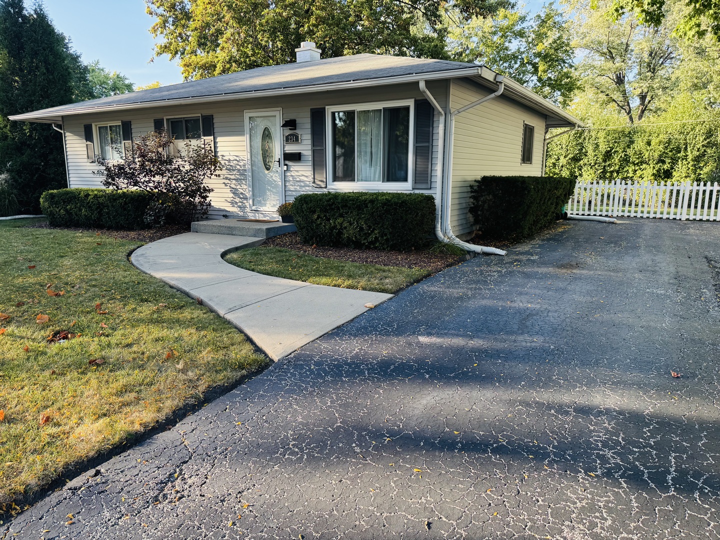 a front view of house with a garden and patio
