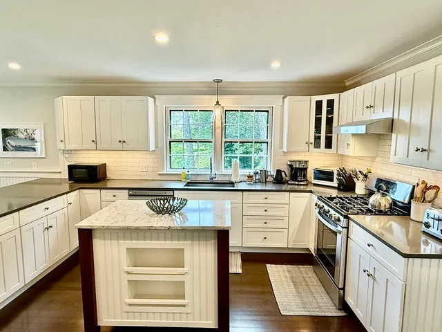 a kitchen with a sink stainless steel appliances and counter space
