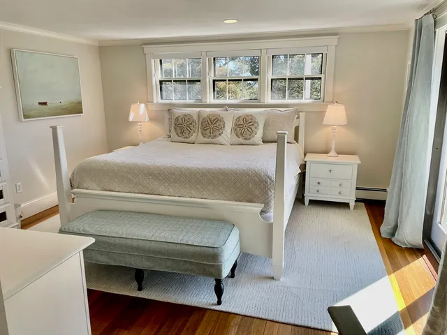 a bedroom with a bed and a large window