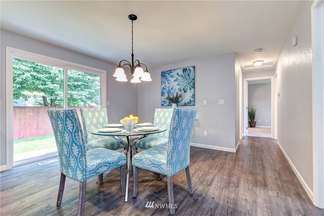 2623 171st Street Southeast Bothell, WA 98012 - Photo 13 of 26 a view of a dining room with furniture window and wooden floor