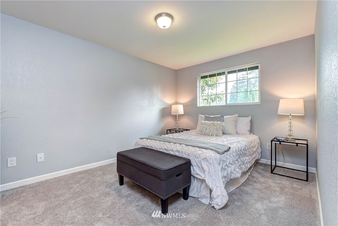 2623 171st Street Southeast Bothell, WA 98012 - Photo 17 of 26 a spacious bedroom with a bed and a lamp