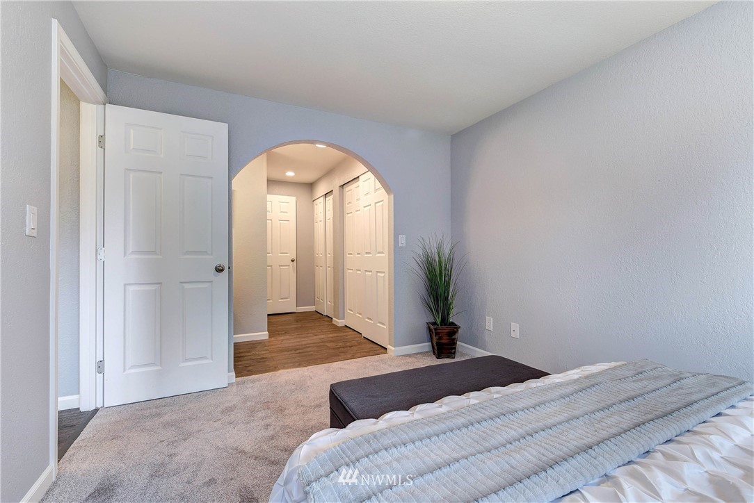 2623 171st Street Southeast Bothell, WA 98012 - Photo 19 of 26 a bedroom with a bed and a chandelier