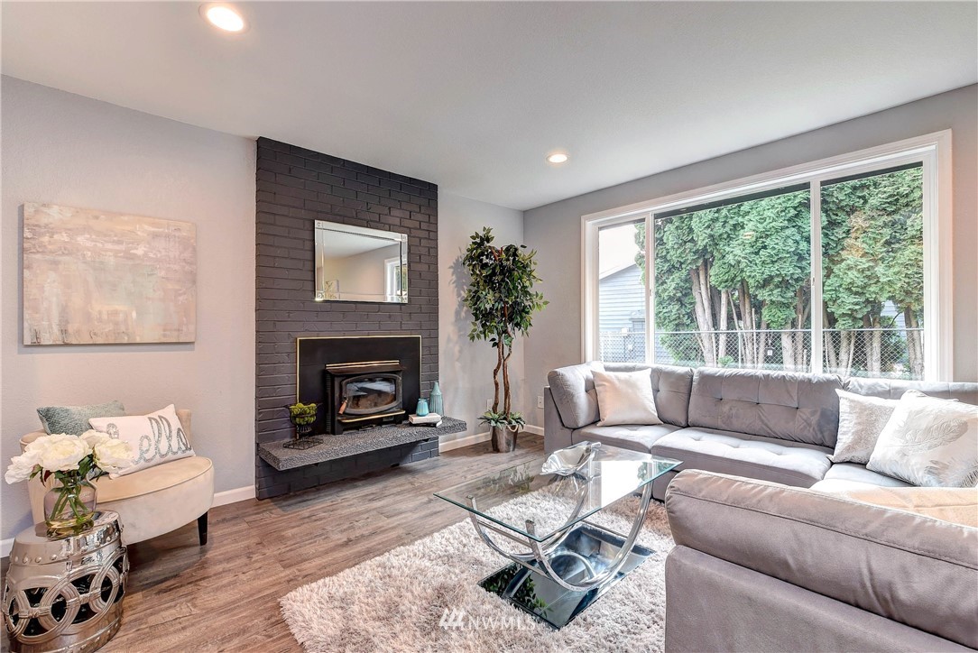 2623 171st Street Southeast Bothell, WA 98012 - Photo 3 of 26 a living room with furniture a fireplace and a large window