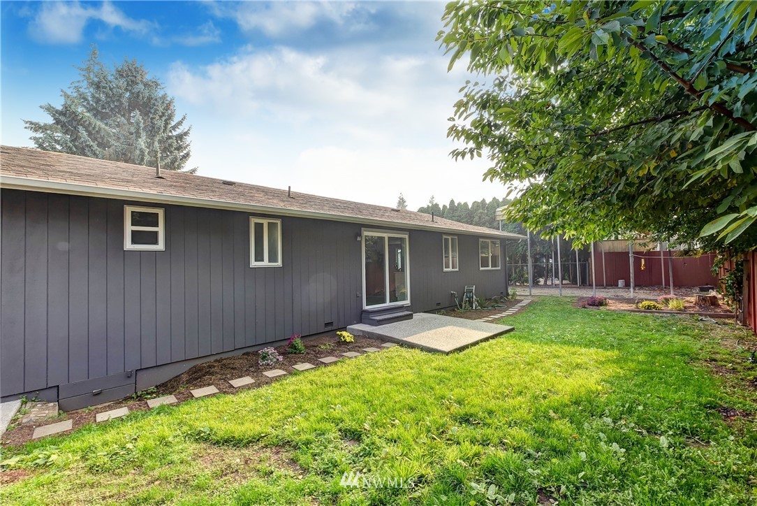 2623 171st Street Southeast Bothell, WA 98012 - Photo 21 of 26 a view of a backyard with table and chairs and wooden fence