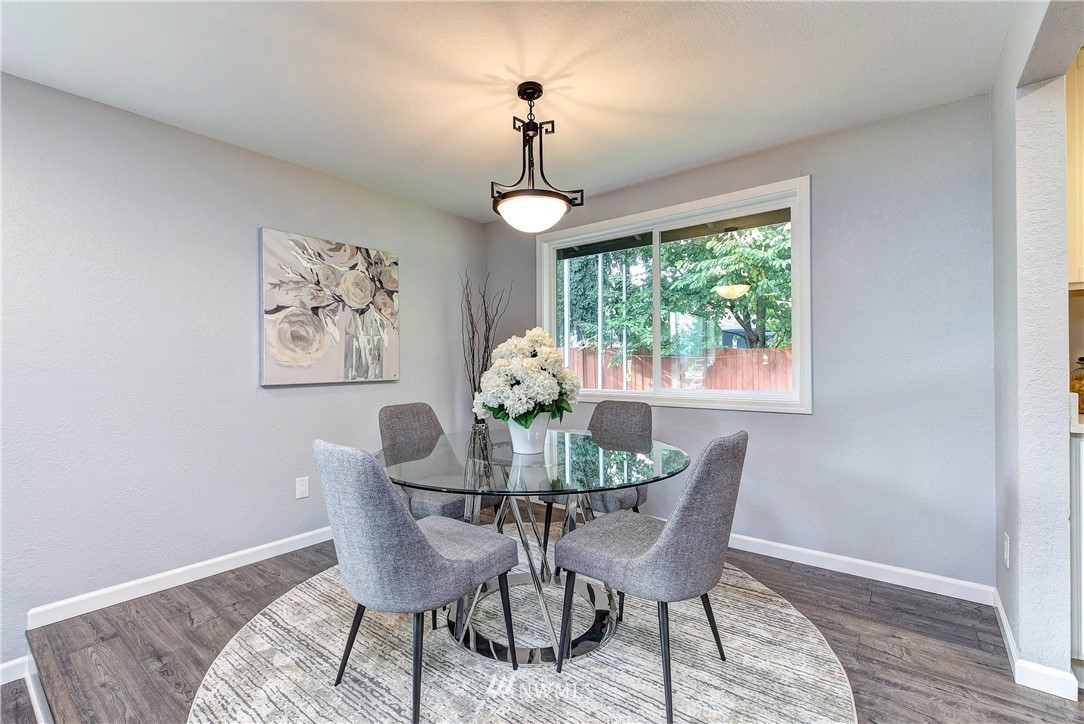 2623 171st Street Southeast Bothell, WA 98012 - Photo 7 of 26 a dining room with furniture a chandelier and wooden floor