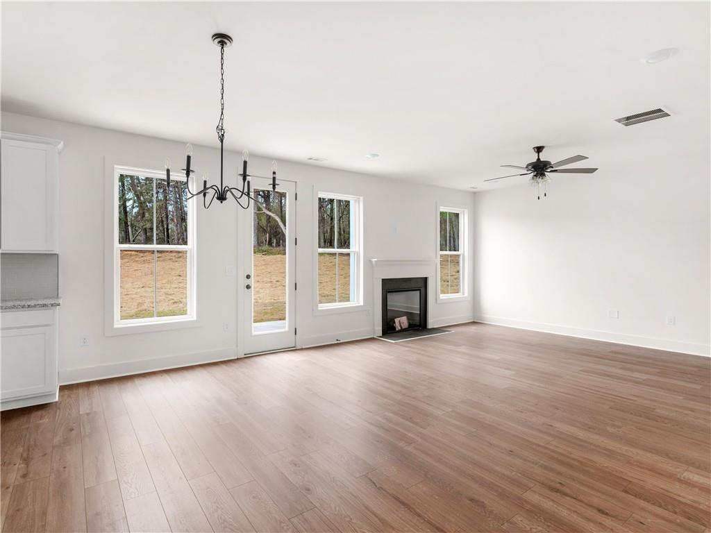202 Loyd Road Mansfield, GA 30055 - Photo 11 of 23 a view of empty room with wooden floor and fireplace