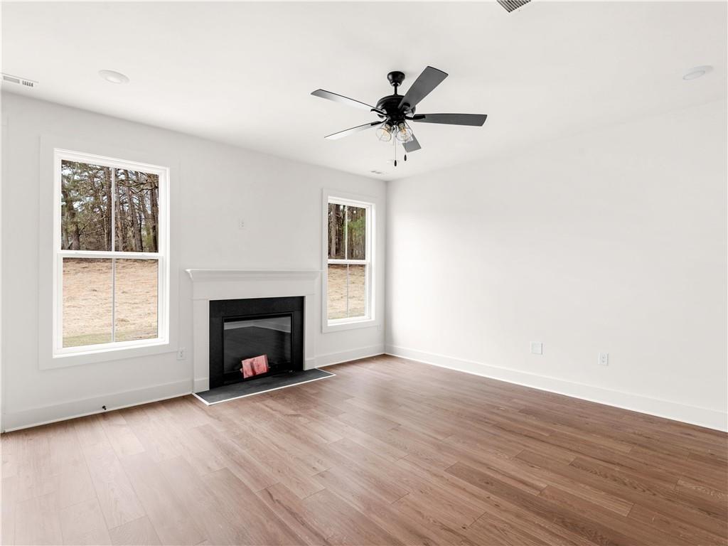 202 Loyd Road Mansfield, GA 30055 - Photo 12 of 23 a view of a livingroom with a fireplace a ceiling fan and hardwood floor
