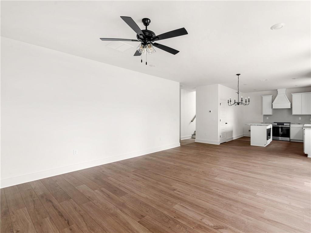 202 Loyd Road Mansfield, GA 30055 - Photo 14 of 23 a view of a livingroom with a hardwood floor and a ceiling fan