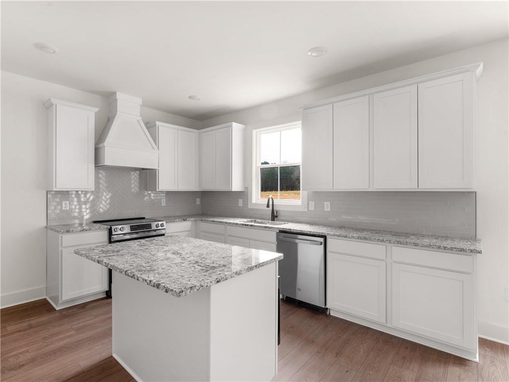 202 Loyd Road Mansfield, GA 30055 - Photo 23 of 23 a kitchen with granite countertop white cabinets and a sink