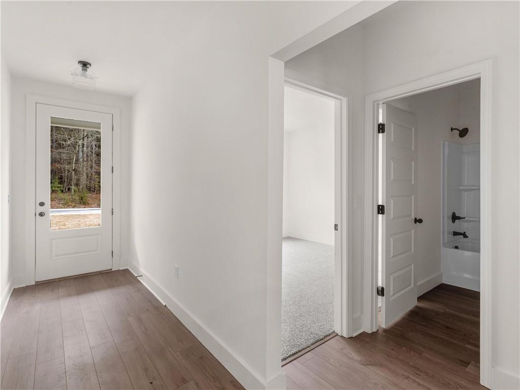 202 Loyd Road Mansfield, GA 30055 - Photo 9 of 23 a view of an empty room with wooden floor and a window