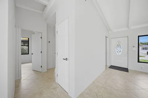 an empty room with a ceiling fan and a window