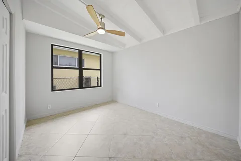 an empty room with windows and closet