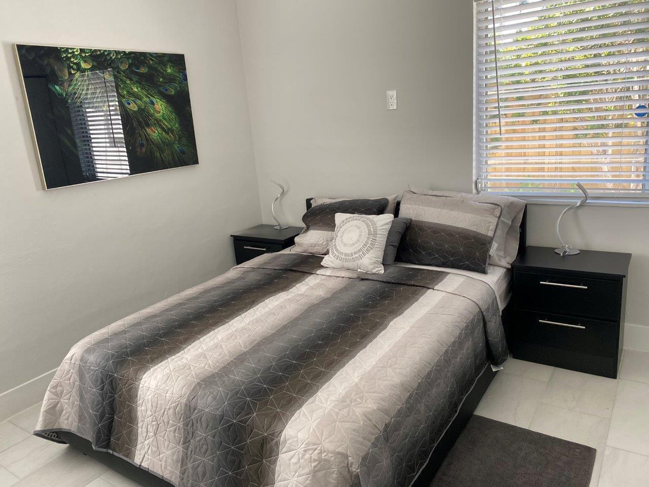 462 Hastings Street Boca Raton, FL 33487 - Photo 11 of 28 a bedroom with a bed and a night stand