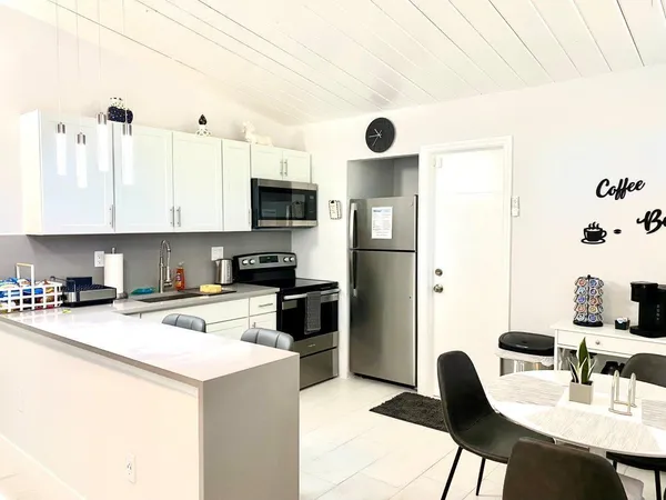 a kitchen with a sink cabinets and appliances