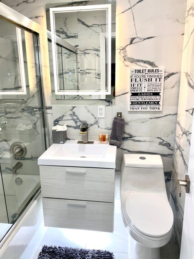 462 Hastings Street Boca Raton, FL 33487 - Photo 20 of 28 a bathroom with a toilet sink and mirror