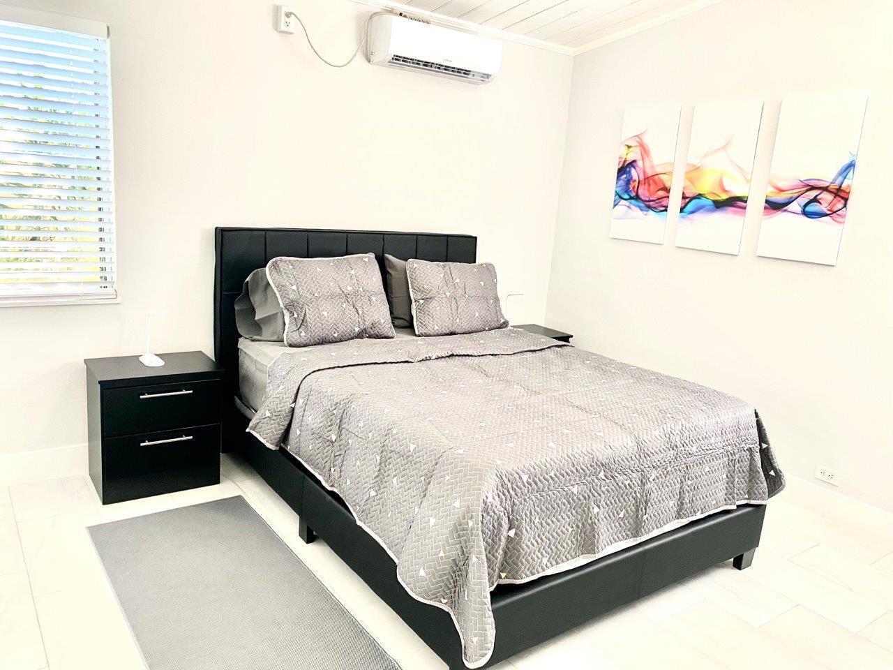 462 Hastings Street Boca Raton, FL 33487 - Photo 22 of 28 a large bed sitting in a bedroom next to a window