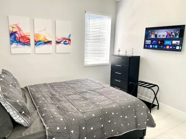 a bedroom with a bed and a window