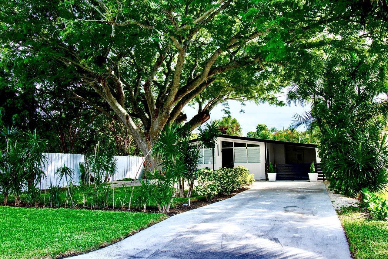 462 Hastings Street Boca Raton, FL 33487 - Photo 27 of 28 a front view of a house with a yard and a garden