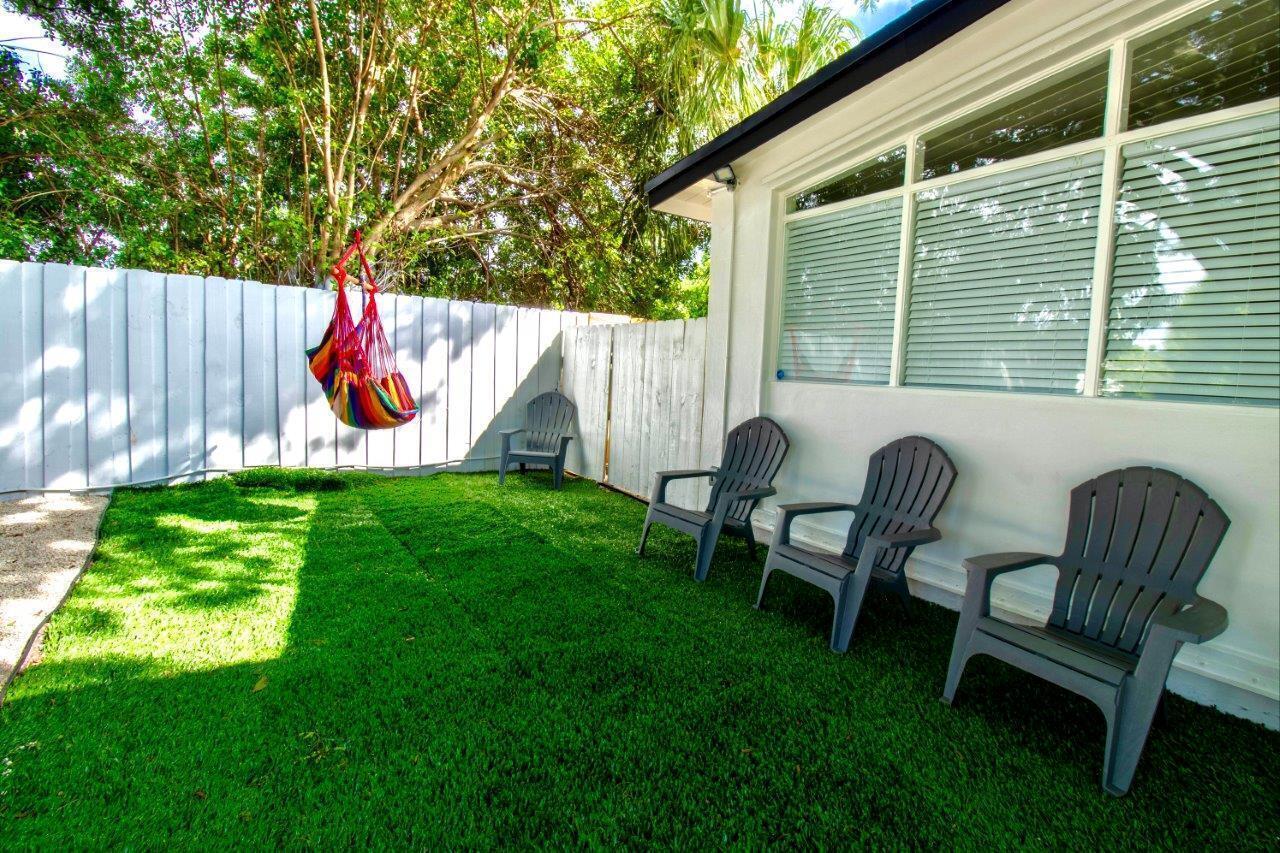 462 Hastings Street Boca Raton, FL 33487 - Photo 6 of 28 a view of backyard with wooden fence and a bench