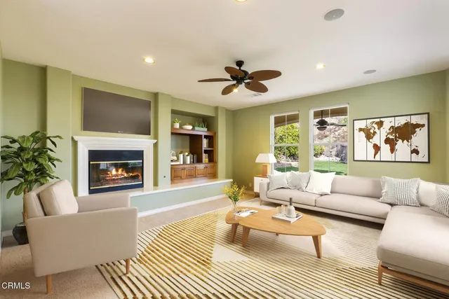 a living room with furniture and a fireplace
