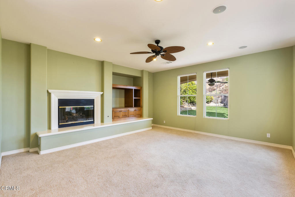 3710 Sunset Ridge Road Altadena, CA 91001 - Photo 13 of 45 a view of an empty room with a window and a fireplace