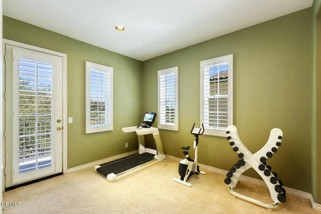 a view of a room with gym equipment and windows