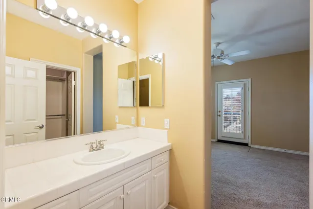 a en suite bathroom with a sink and a mirror