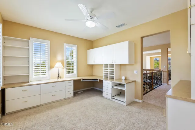 a large white kitchen with a window and cabinets