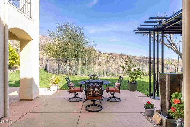 a view of a patio with a table chairs and a potted plants