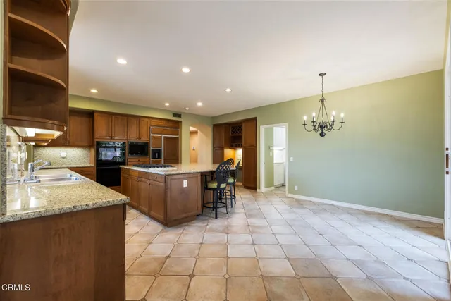 a kitchen with stainless steel appliances granite countertop a sink and a stove