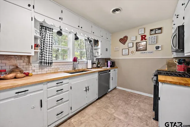 a kitchen with granite countertop a sink and cabinets